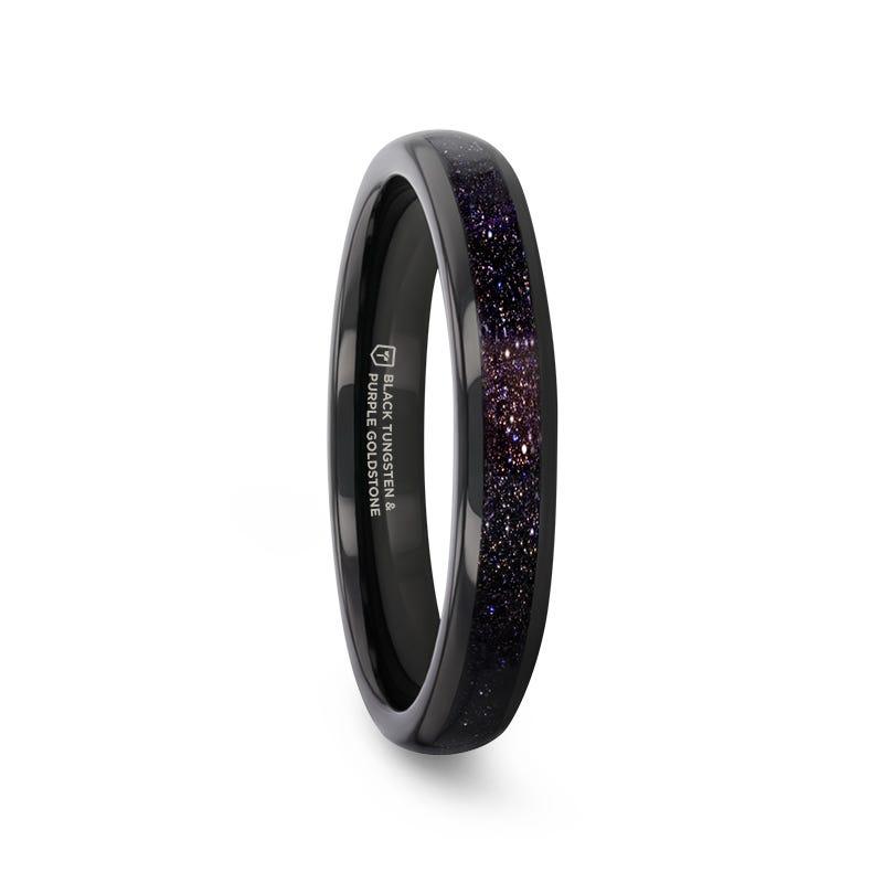 Black ceramic ring with purple and blue speckled interior on a white background