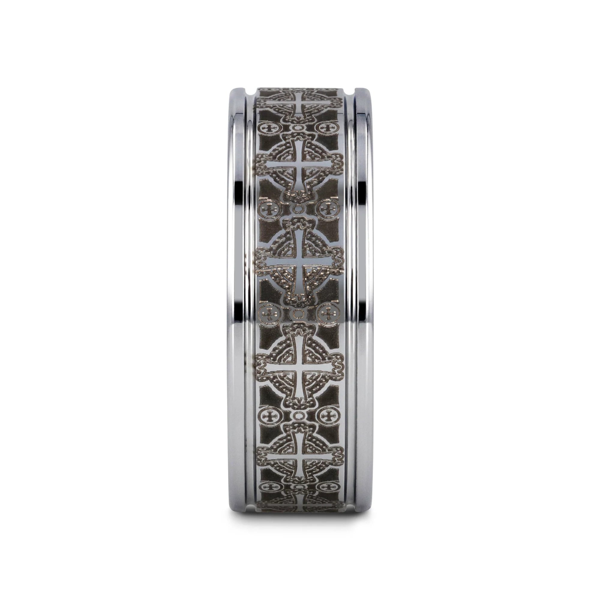 Silver ring with intricate black and white designs on a white background