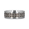 Silver ring with intricate black and white designs on a white background