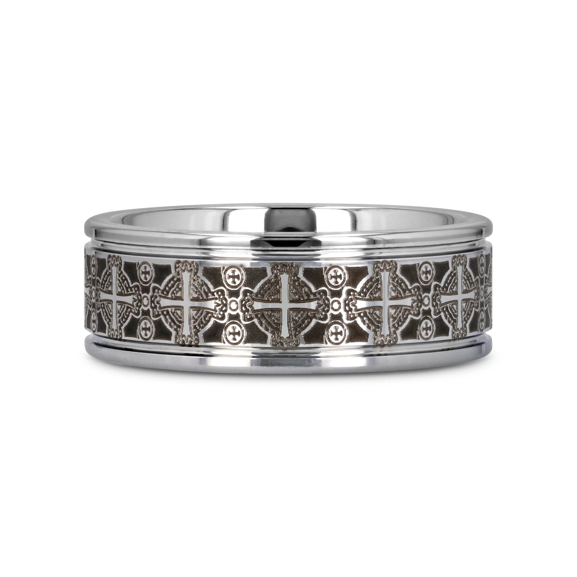 Silver ring with intricate black and white designs on a white background